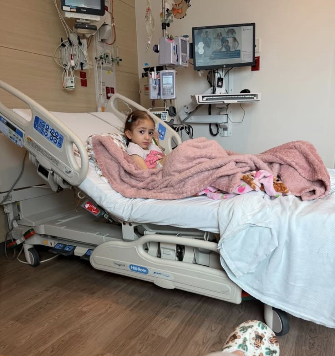 Mia Duarte, five years old, resting in her hospital bed